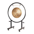 Side view of the Divine Energy Mandala Gong on a black metal stand, highlighting its design and proportions.