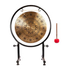 The Mandala Harmony Gong on a metal stand with a wooden mallet placed next to it, showcasing the complete set.